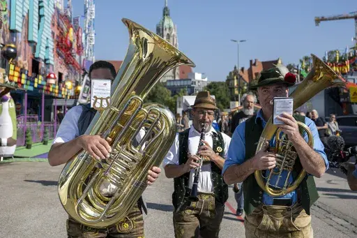 A brass band plays during a press tour at the Oktoberfest, in Munich, Germany, Thursday, Sept. 19, 2024. (Lennart Preiss/dpa via AP)