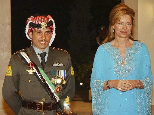 Jordan's then Crown Prince Hamzeh, left, with his mother then Queen Noor, during his wedding ceremony in Amman, Jordan, May 27, 2004. Prince Hamzeh, the half-brother of Jordan’s king, posted a letter on his official Twitter account on Sunday, April 3, 2022, relinquishing his princely title, a year after a rare palace feud saw him placed under house arrest. (AP Photo/Hussein Malla, File)