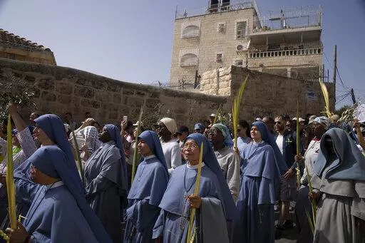 Nuns walk in the Palm Sunday procession on the Mount of Olives in Jerusalem, Sunday, April 10, 2022. (AP Photo/Maya Alleruzzo)