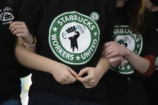 Starbucks employees and supporters link arms during a union election watch party Dec. 9, 2021, in Buffalo, N.Y. The U.S. Supreme Court is set to hear oral arguments in a case filed by Starbucks against the National Labor Relations Board. (AP Photo/Joshua Bessex, File)