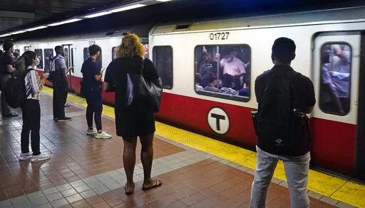 Commuters wait as a train full of passengers arrives at the South Station Red Line subway stop, Wednesday, July 13, 2022, in Boston. Boston's public transit system is a mess, harried commuters and officials are increasingly looking to a Chinese-owned subway car manufacturer to account for some of the troubles. There have been fatal accidents, subway car collisions, malfunctioning elevators, and trains running on weekend schedules during rush hour. (AP Photo/Charles Krupa)
