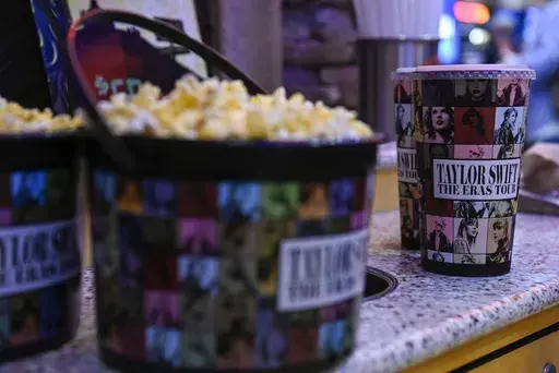 A collection bucket and cup for "Taylor Swift: The Eras Tour" film is sold at Regal Cinemas, Oct. 13, 2023, in Lynchburg, Va. (Paige Dingler/The News & Advance via AP, File)