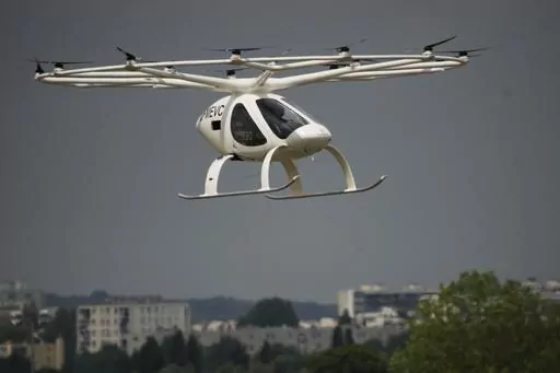 The Volocopter 2X, an electric vertical takeoff and landing multicopter, performs a demonstration flight during the Paris Air Show in Le Bourget, north of Paris, France, Monday, June 19, 2023. (AP Photo/Lewis Joly)
