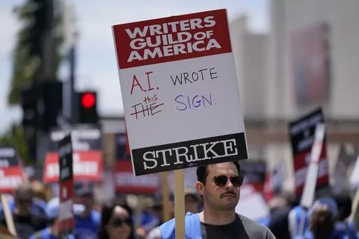 Members of the The Writers Guild of America picket outside Fox Studios on Tuesday, May 2, 2023, in Los Angeles. Getting control of the use of artificial intelligence is a central issue in the current strikes of Hollywood's actors and writers, which on Friday, July 21, 2023, entered its second week. (AP Photo/Ashley Landis, File)