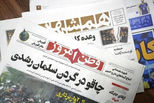 The front pages of the Aug. 13 edition of the Iranian newspapers, Vatan-e Emrooz, front, with title reading in Farsi: "Knife in the neck of Salman Rushdie," and Hamshahri, rear, with title: "Attack on writer of Satanic Verses," are pictured in Tehran Saturday, Aug. 13, 2022. Rushdie, whose novel “The Satanic Verses” drew death threats from Iran’s leader in the 1980s, was stabbed in the neck and abdomen Friday by a man who rushed the stage as the author was about to give a lecture in wester