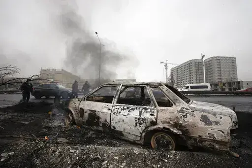 A car, which was burned after clashes, is seen on a street in Almaty, Kazakhstan, Friday, Jan. 7, 2022. Kazakhstan's president authorized security forces on Friday to shoot to kill those participating in unrest, opening the door for a dramatic escalation in a crackdown on anti-government protests that have turned violent. The Central Asian nation this week experienced its worst street protests since gaining independence from the Soviet Union three decades ago, and dozens have been killed in the 