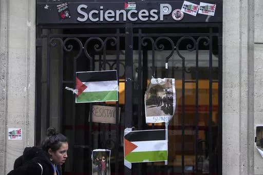 A student walks past th entrance of Sciences-Po university in Paris Friday, April 26, 2024. Students in Paris inspired by Gaza solidarity encampments at campuses in the United States blocked access to a campus building at a prestigious French university Friday, prompting administrators to move all classes online. The pro-Palestinian protest at the Paris Institute of Political Studies, known as Sciences Po, came two days after police broke up a separate demonstration at one of the university's am