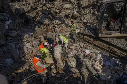 Members of a search and rescue team work on a collapsed structure after the earthquake in Antakya, southeastern Turkey, Sunday, Feb. 12, 2023. Starting Monday, a crucial Twitter tool known as Application Developer Interface, used by software developers to comb the platform for calls for help from earthquake victims, may be accessible only by paying a $100 monthly fee. (AP Photo/Bernat Armangue, File)