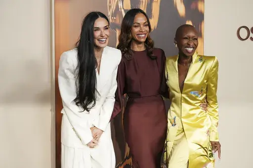 Demi Moore, from left, Zoe Saldana, and Cynthia Erivo arrive at the Oscars Nominees Dinner on Tuesday, Feb. 25, 2025, at the Academy Museum of Motion Pictures in Los Angeles. (Photo by Jordan Strauss/Invision/AP)