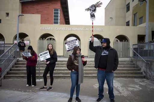 Teaches and supporters picket outside Cesar Chavez Learning Academy in San Fernando, Calif., Thursday, March 23, 2023, on the third day of a strike by SEIU and supported by UTLA for higher wages for Angeles Unified School District support staff. The 3-day strike left thousands of students out of class. (David Crane/The Orange County Register via AP)