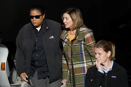 House Speaker Nancy Pelosi, middle, is escorted to a vehicle outside of her and husband Paul Pelosi's home in San Francisco, Wednesday, Nov. 2, 2022. (AP Photo/Jeff Chiu)