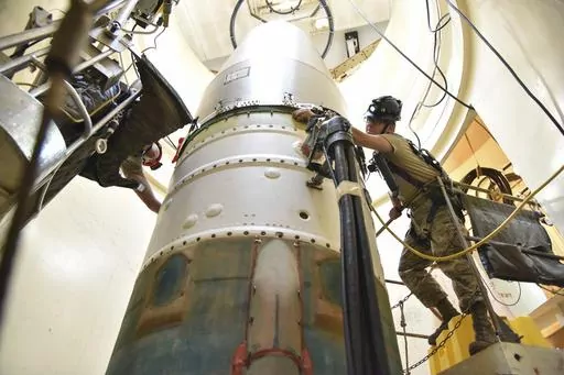 In this image provided by the U.S. Air Force, Airman 1st Class Jackson Ligon, left, and Senior Airman Jonathan Marinaccio, 341st Missile Maintenance Squadron technicians, connect a re-entry system to a spacer on an intercontinental ballistic missile during a Simulated Electronic Launch-Minuteman test Sept. 22, 2020, at a launch facility near Malmstrom Air Force Base in Great Falls, Mont. The Air Force says a review of a Montana nuclear missile base where an unusual number of troops have reported