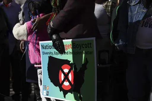 A community member holds a sign calling for a national boycott of Target stores during a news conference outside Target Corporation's headquarters Thursday, Jan. 30, 2025, in Minneapolis, Minn. (AP Photo/Ellen Schmidt, File)