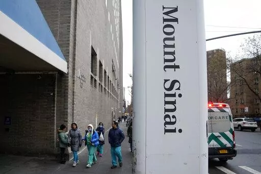 People enter Mount Sinai Hospital in New York, Thursday, Jan. 12, 2023. Two New York City hospitals have reached a tentative contract agreement with thousands of striking nurses that ends the walkout, the nurses' union announced today. (AP Photo/Seth Wenig)