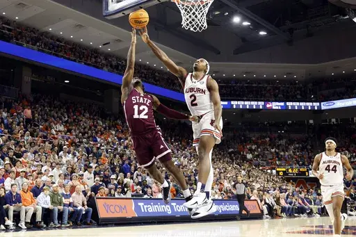 Auburn guard Denver Jones (2) blocks the shot attempt of Mississippi State guard Josh Hubbard (12) during the first half of an NCAA college basketball game, Tuesday, Jan. 14, 2025, in Auburn, Ala. (AP Photo/Butch Dill)