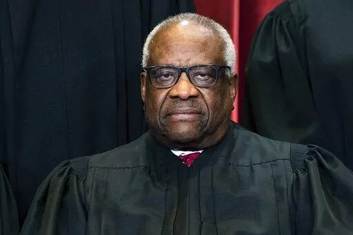Justice Clarence Thomas sits during a group photo at the Supreme Court in Washington, on Friday, April 23, 2021. Thomas has been hospitalized because of an infection, the Supreme Court said Sunday, March 20, 2022. Thomas, 73, has been at Sibley Memorial Hospital in Washington, D.C., since Friday, March 18 after experiencing “flu-like symptoms,” the court said in a statement. (Erin Schaff/The New York Times via AP, Pool, File)