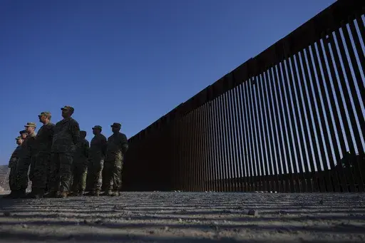 Members of the California National Guard listne during a news conference near the Otay Mesa Port of Entry along the border with Mexico, Dec. 5, 2024, in San Diego. (AP Photo/Gregory Bull, File)