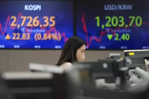 A currency trader watches monitors at the foreign exchange dealing room of the KEB Hana Bank headquarters in Seoul, South Korea, Thursday, March 3, 2022. Asian stock markets rebounded Thursday and oil prices climbed higher after the head of the Federal Reserve said he supports a smaller rise in interest rates than some expected. (AP Photo/Ahn Young-joon)