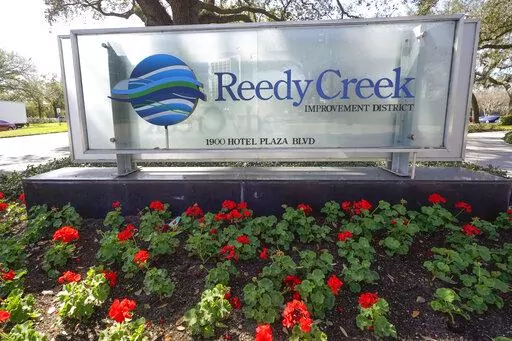 A sign near the entrance of the Reedy Creek Improvement District administration building is seen Monday, Feb. 6, 2023, in Lake Buena Vista, Fla. Disney’s government in Florida was the envy of any private business, giving it unprecedented powers in deciding what and how to build at Walt Disney World. Those days are numbered as a new bill released in early February 2023 puts the entertainment giant’s district firmly in the control of Florida’s governor and legislative leaders. (AP Photo/John
