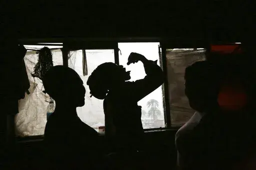 A man takes cough medicine used as a drug in Mbare, Harare, in this Saturday, Nov. 20, 2021. In Zimbabwe, the COVID-19 pandemic has driven up mental health problems caused by substance abuse. Health professionals are seeing a marked rise in crises caused by drug use. Authorities and campaigners attribute the rise in drug abuse to loss of employment, prolonged school closures, stress and anxiety resulting from COVID-19. ( AP Photo/Tsvangirayi Mukwazhi)