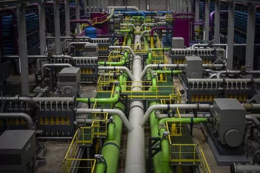 A worker walks over the pipeline that transports seawater to filters at Europe's largest desalination plant for drinking water located in Barcelona, Spain, Tuesday, May 16, 2023. Europe's largest desalination plant for drinking water had largely remained idle since its construction near Barcelona over a decade ago. But since a prolonged drought gripped Spain, the plant has been running at full throttle. (AP Photo/Emilio Morenatti)