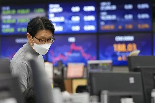 A currency trader watches monitors at the foreign exchange dealing room of the KEB Hana Bank headquarters in Seoul, South Korea, Friday, Feb. 11, 2022. Shares were mostly lower Friday in Asia after a sell-off on Wall Street spurred by news that U.S. inflation jumped 7.5% in January, which raised expectations the Federal Reserve will need to move forcefully to cool the economy by raising interest rates. (AP Photo/Ahn Young-joon)