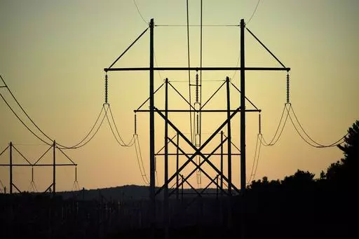 Central Maine Power utility lines are seen on Oct. 6, 2021, in Pownal, Maine. It’s one of President Joe Biden’s thorniest challenges as he pursues ambitious reductions in greenhouse gas emissions. If he can't streamline the permitting process for power plants, transmission lines and other projects, the country is unlikely to have the infrastructure needed for a future powered by carbon-free electricity. (AP Photo/Robert F. Bukaty, File)