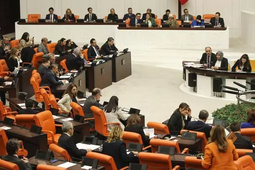 Turkish lawmakers follow the debate of Sweden's bid to join NATO at the Turkish Parliament in Ankara, Turkey, Tuesday, Jan. 23, 2024. Turkish legislators on Tuesday endorsed Sweden's membership in NATO, lifting a major hurdle on the previously nonaligned country's entry into the military alliance. (AP Photo/Ali Unal)